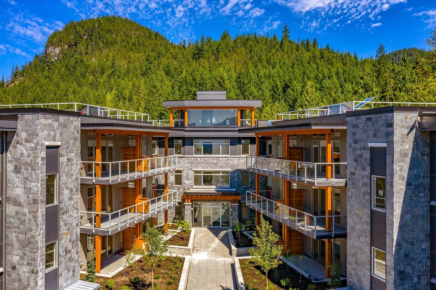 Skyridge apartment courtyard below a forested mountain