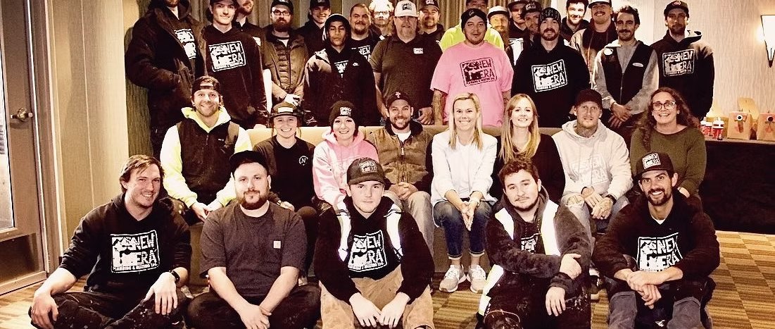 The New Era team together indoors, many in New Era hoodies and hats